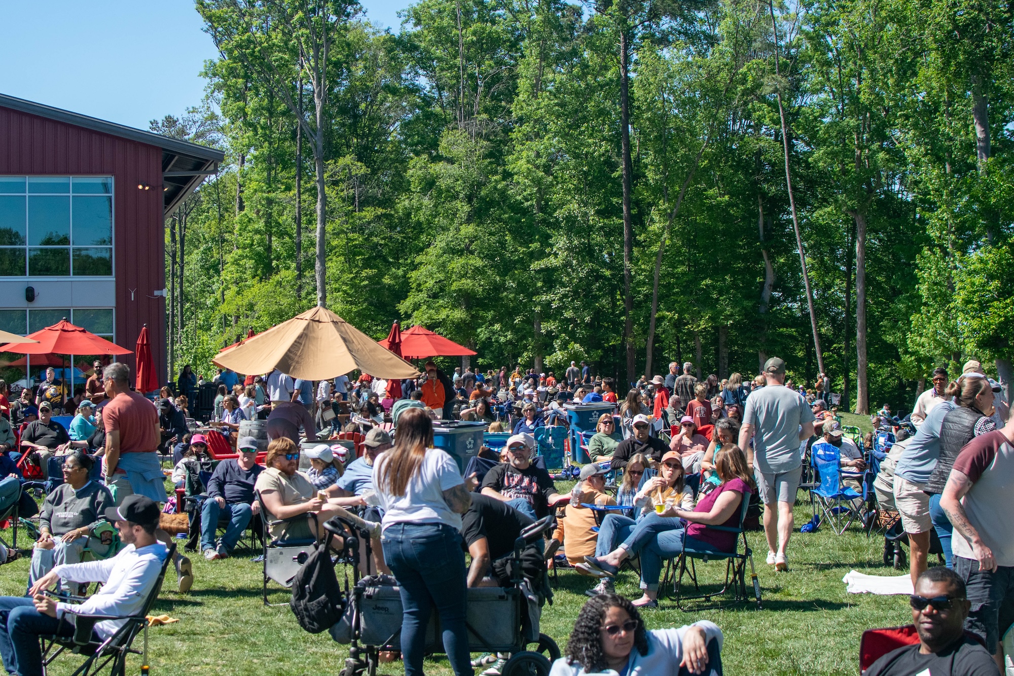 RVA Taco Festival 2026 - Crowd of attendees relaxing in lawn chairs under umbrellas with Hardywood West Creek in the background